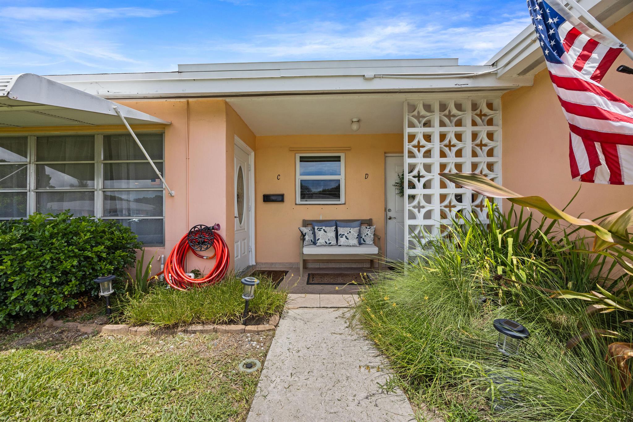 Spacious villa-style condo in High Point Section 3 of Boynton Beach,. 1-bedroom, 1.5-bathroom unit features newer laminate flooring throughout. Updated kitchen with stainless steel appliances. Beautiful built-ins on the dining room wall create a showcase feature wall sure to be the focus of the living areas. Bedroom offers 2 oversized closets plus a hall closet for storage needs Convenient half bath when company visits. Full hurricane protection plus a hurricane rated door. Enclosed lanai can be used as office space and large open patio with plenty of greenspace to enjoy the outdoors. Laundry room is adjacent to the unit.