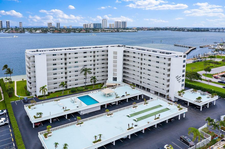 Offered as an furnished Annual.  May consider a 6 month+ term - rate to be negotiated. Fabulous blue water Intracoastal views from this Penthouse updated condo. Views of Singer Island & yachts/boats cruising along the Intracoastal.  Wood & tile floors. Newer furniture. King bed in Primary BR with huge walk in Closet. Primary bathroom has double sinks & combo tub/shower.  Twin beds in 2nd BR. Washer/Dryer in unit. Impact storm windows. Bar area for cocktail hour complete with a wine cooler. Community heated Pool. CarPort. Gated Community entrance. Located next door to Lake Park Marina & within walking distance to parks.