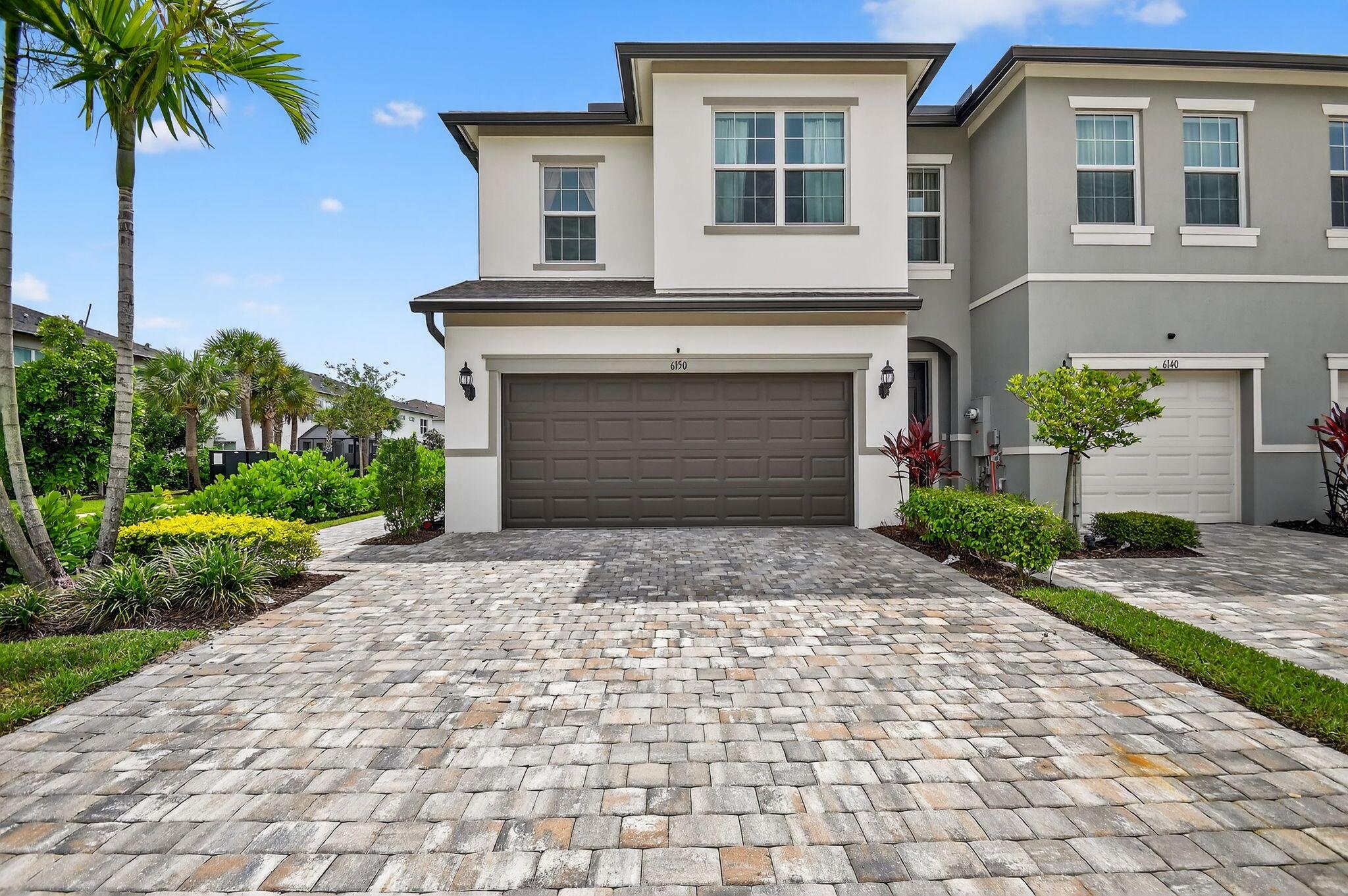 Nestled in the heart of the Ranchette Road Townhomes community, this nearly-new lakefront townhome delivers a seamless blend of elegance, comfort, and modern convenience. Built in 2023, this beautiful end-unit residence offers 3 bedrooms, 2.5 bathrooms, and 1,675 square feet of air-conditioned living space within a total of 2,091 square feet, including a spacious 2-car garage.The home's stunning curb appeal begins with a beautifully landscaped front yard, stone paver driveway, and a welcoming covered entryway. Inside, you'll find an open-concept main level with ceramic tile flooring, leading into a bright and airy living area filled with natural light.