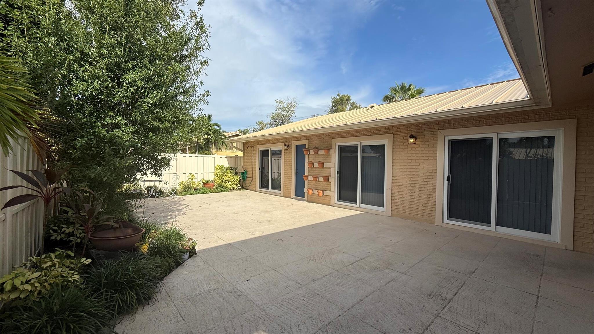 Gorgeous 3 Bedroom, 2 Bathroom Villa in Palm Beach Gardens! This bright and airy home features vaulted ceilings, an updated kitchen with marble countertops, and beautifully renovated bathrooms. The split floor plan offers a spacious principal suite, while guest bedrooms share a bath with a designer-tiled shower. Wood-look tile flooring runs throughout for a modern touch. Enjoy peace of mind with impact storm windows and relax on the huge open patio. Ideally located near world-class golf courses, premier dining, shopping, and top-rated schools.