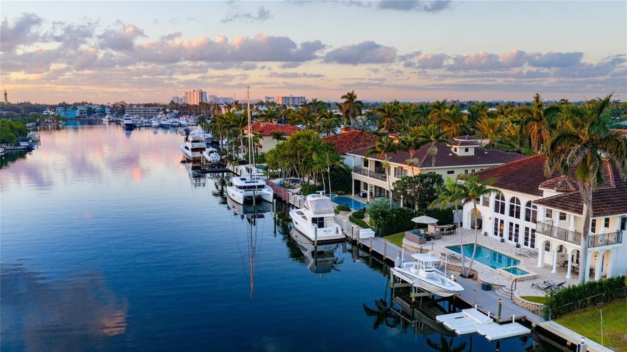 Best view in Lighthouse Point! Gracious architecture, stunning wide waterway views, and fresh light-filled interiors artfully combine in this glorious yachting estate with 90'± of full-service dockage on beautiful Lake Placid. Rebuilt in 2014, this custom estate reveals five bedrooms, four full baths and one-half bath. Features include impact windows and doors, 2 bay garage, s-tile roof, updated 3 zone a/c, polished marble floors, newly renovated kitchen, and two-story great room/fireplace. Outdoor entertainment is enjoyed at the resort style, heated/saltwater pool with spill-over spa. Ideal for the boating enthusiast there is a 90' composite yacht dock complete with 15k-lbs boat lift just minutes from the Hillsboro Inlet! Shown by appointment only.