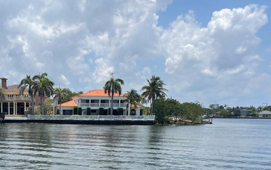 Southern colonial home on lg point lot at Intracoastal & Southalke, has approx 5,000 SF & water view from every rm. Entrance has 2 story foyer w/ a spiral marble staircase to a 4 bed 5 ½ bath home. Features include white marble flrs thru-out, marble baths, solid wood raised panel doors & trim, 10’ ceilings, accordion hurricane shutters, extra lg rms, huge eat-in kitchen w/ custom oak cabinets & marble counters, generous size family rm w/ wet-bar & fireplace, huge 1st floor office, formal living & dining rms. Master suite & all upstairs bedrooms have glass doors to a large roofed balcony facing the water, the master is super size w/ 2 marble baths & a morning bar. An open pool & spa w lg, covered veranda face the water. Extra lg, 2 car garage. Needs renovation, as-is sale.