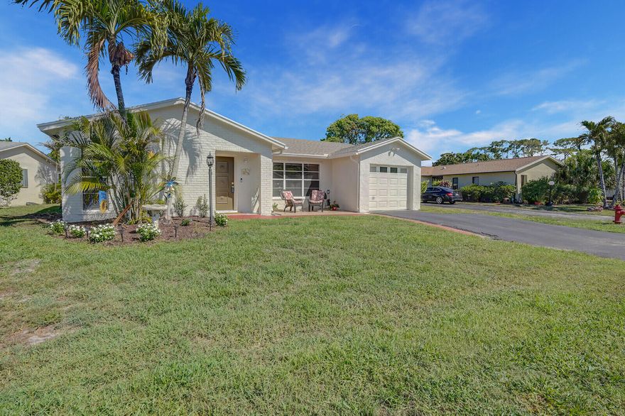 Escape to serene lakefront living in this spacious 3 bedroom, 2 bath home with attached 1 car garage. Nestled on a larger lot backing directly to a beautiful lake, you'll enjoy peaceful water views and the perfect Florida lifestyle right from your backyard. The heart of the home shines with a beautifully renovated kitchen featuring sleek quartz countertops, modern finishes, and plenty of space for everyday living and entertaining. A fresh new roof (installed in September 2025) adds peace of mind and long-term value. The flexible den offers endless possibilities, use it as a home office, cozy reading nook, or easily convert it into a third bedroom for growing families or guests. All ages are welcome in this low-HOA community, where fees cover high-speed fiber internet and cable for effortless connectivity. Prime location just minutes from the renowned Palm Beach National Golf Course and driving range, perfect for golf enthusiasts seeking championship play in a fun, friendly South Florida atmosphere. This is more than a house, it's your private oasis with lake breezes, low-maintenance luxury, and easy access to everything Palm Beach County has to offer. Don't miss this rare opportunity to own lakefront living at its best. Schedule your private showing today!