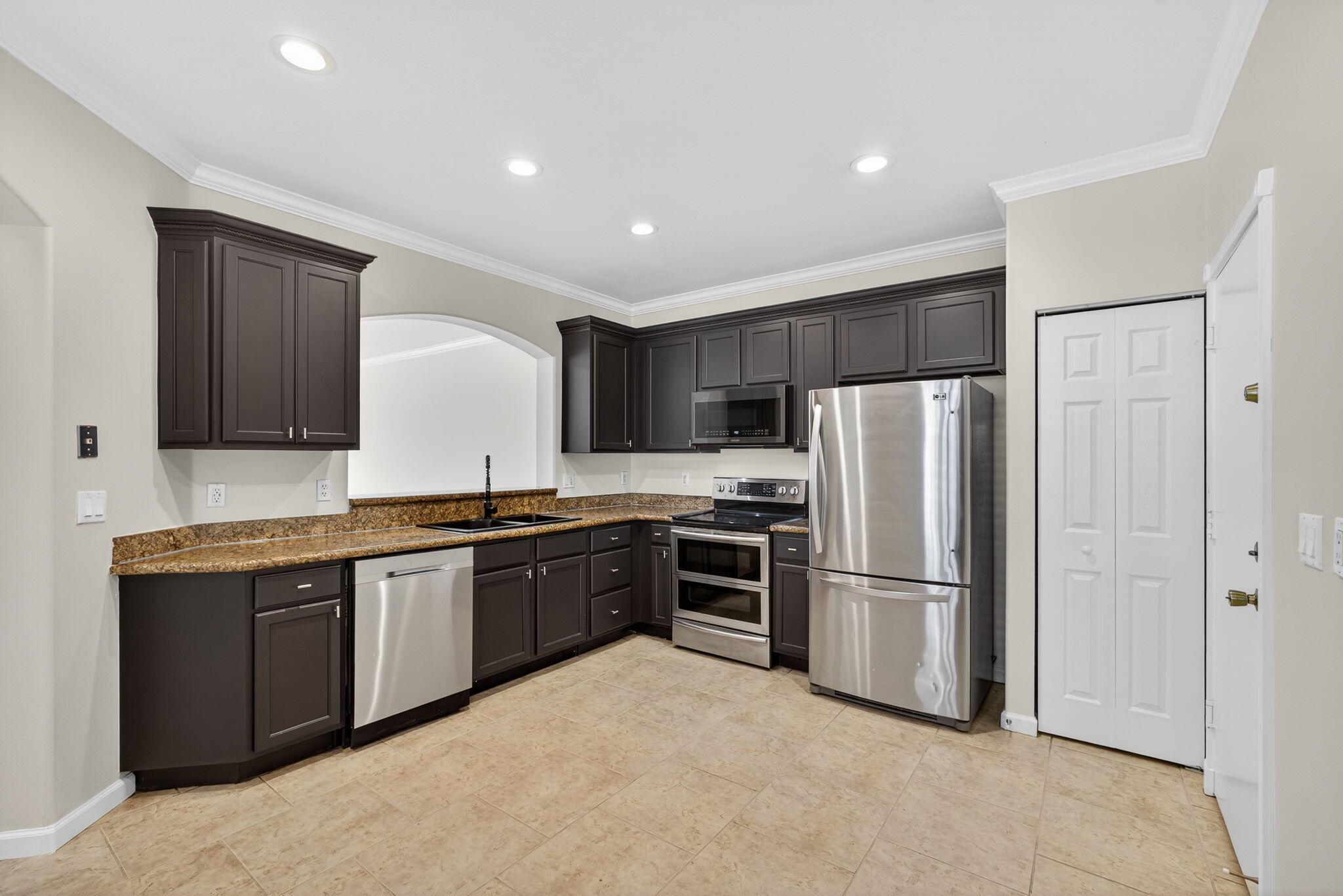 Welcome to 2213 Oakmont Drive, a spacious and freshly updated corner-unit townhome located in the desirable man-gated community of Thousand Oaks in Riviera Beach. Offering 1,872 square feet under air, this home features three bedrooms, two and a half bathrooms, and a versatile loft, with all bedrooms and the loft conveniently located on the second floor. The property includes a two-car garage plus a two-car driveway, providing ample parking. The home has been freshly painted throughout and boasts brand new vinyl flooring upstairs, making it move-in ready. Large windows bring in plenty of natural light, creating a bright and welcoming living space.