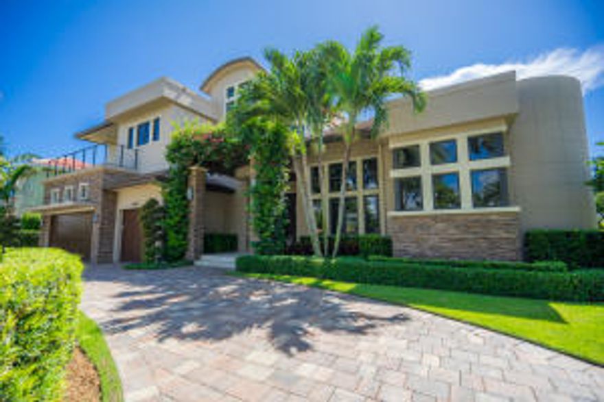 Amazing Location! Our featured property is a rare opportunity in Royal Palm Yacht & Country Club. This estate; built by Qualk Homes in 2012, looks and shows like new! This home features an amazing location. Nestled on a Jack Nicklaus Signature golf course this property has golf views from the front and back of the property! Enjoy a contemporary masterpiece with 5 bedrooms, an office, and 6 1/2 bathrooms. The ground floor features a beautiful master suite with sitting area, his & her walk in closets and spacious his and her master bathrooms.  The lady's suite has a walk in shower, separate tub and dual sinks. The gourmet kitchen has a separate bar area adjacent to dinning room which makes this the perfect home for entertaining.  Other features include: marble and wood floors throughout,