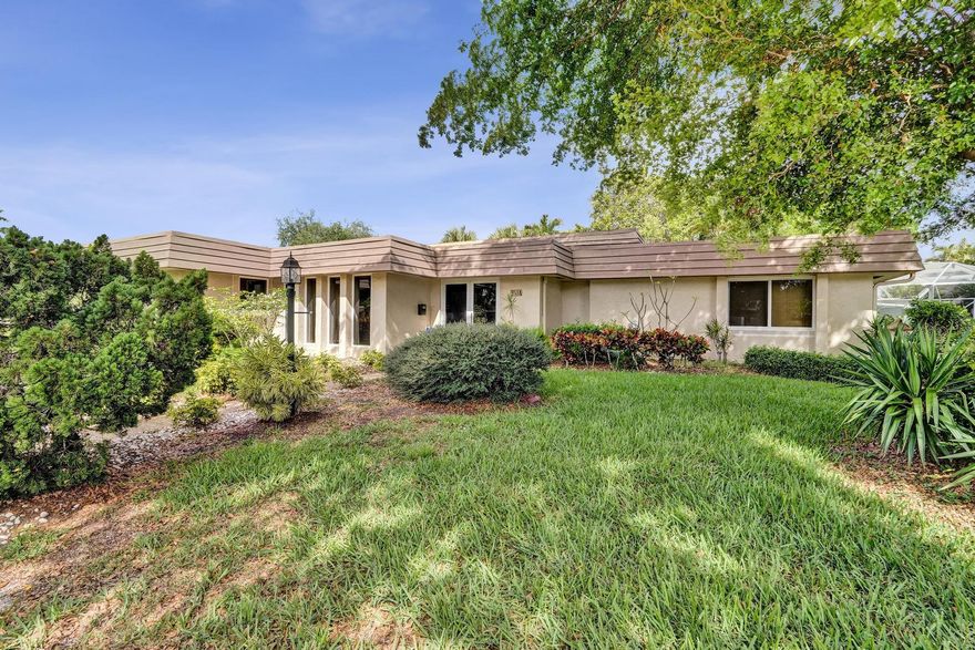 Welcome home to this beautifully maintained 3-bedroom, 3-bath residence in The Woodlands of Tamarac. Situated on an oversized 10,000+ sq. ft. corner lot with lush landscaping, the property offers exceptional privacy and a tranquil setting. Inside, expansive open living areas are complemented by vaulted ceilings and large impact sliding glass doors and windows, creating a bright, airy atmosphere with seamless indoor-outdoor flow. The oversized Florida room offers flexible space for entertaining, relaxing, or creating a home office, studio, or game room. Low HOA includes lawn care.