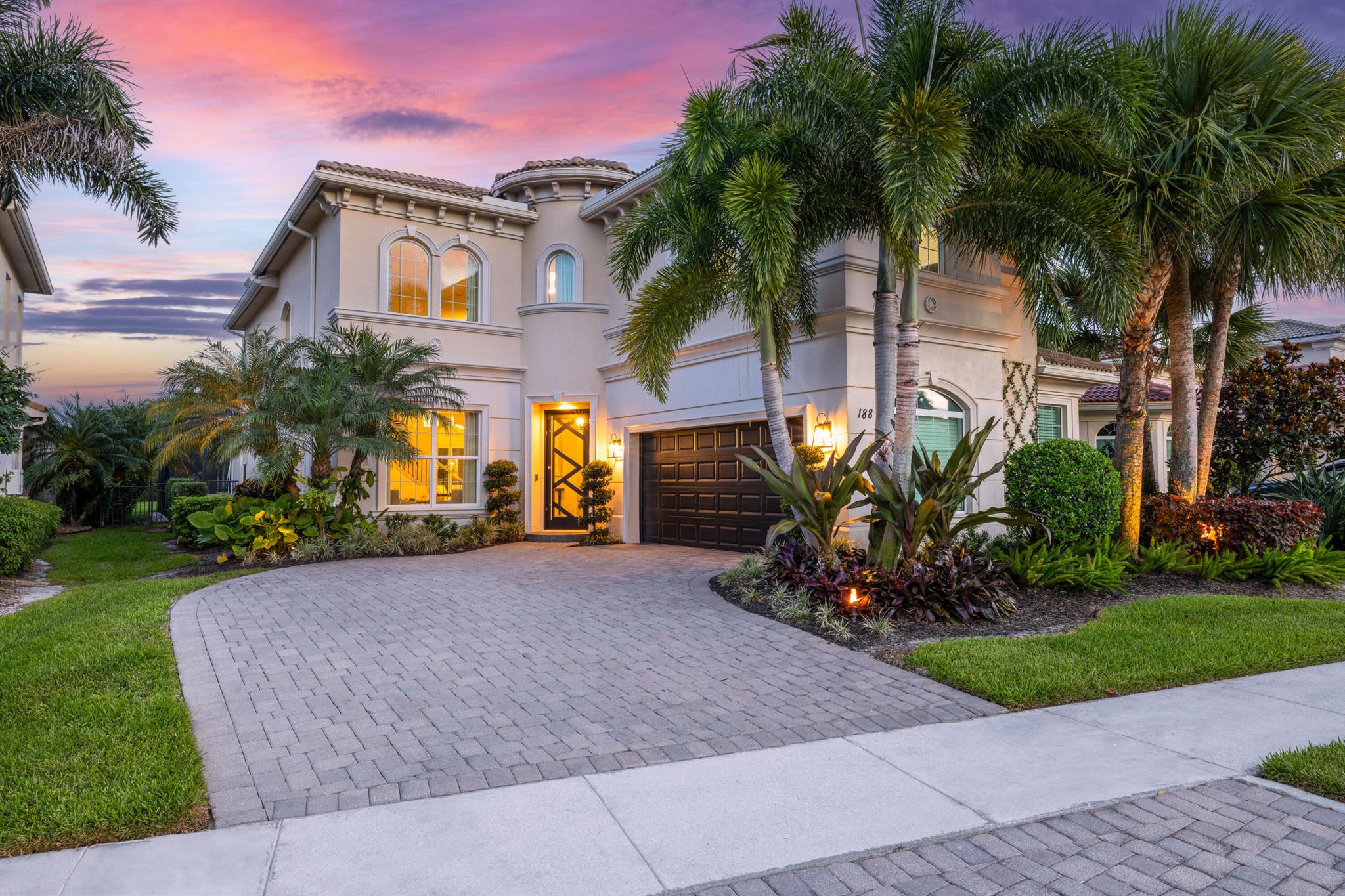 Welcome to 188 Carina Drive, a beautifully updated and meticulously maintained residence located in the prestigious Jupiter Country Club. This stunning home offers 3,598 square feet of thoughtfully designed living space, featuring 4 bedrooms, a versatile loft, and an office or den that can serve as a fifth bedroom.The main level showcases elegant marble flooring and includes the spacious primary suite on the first floor, offering privacy and convenience. All additional bedrooms, along with the loft and office/den, are located upstairs, providing the perfect layout for families, guests, or working from home. The loft makes an ideal space for recreation, a media room, or a second home office.