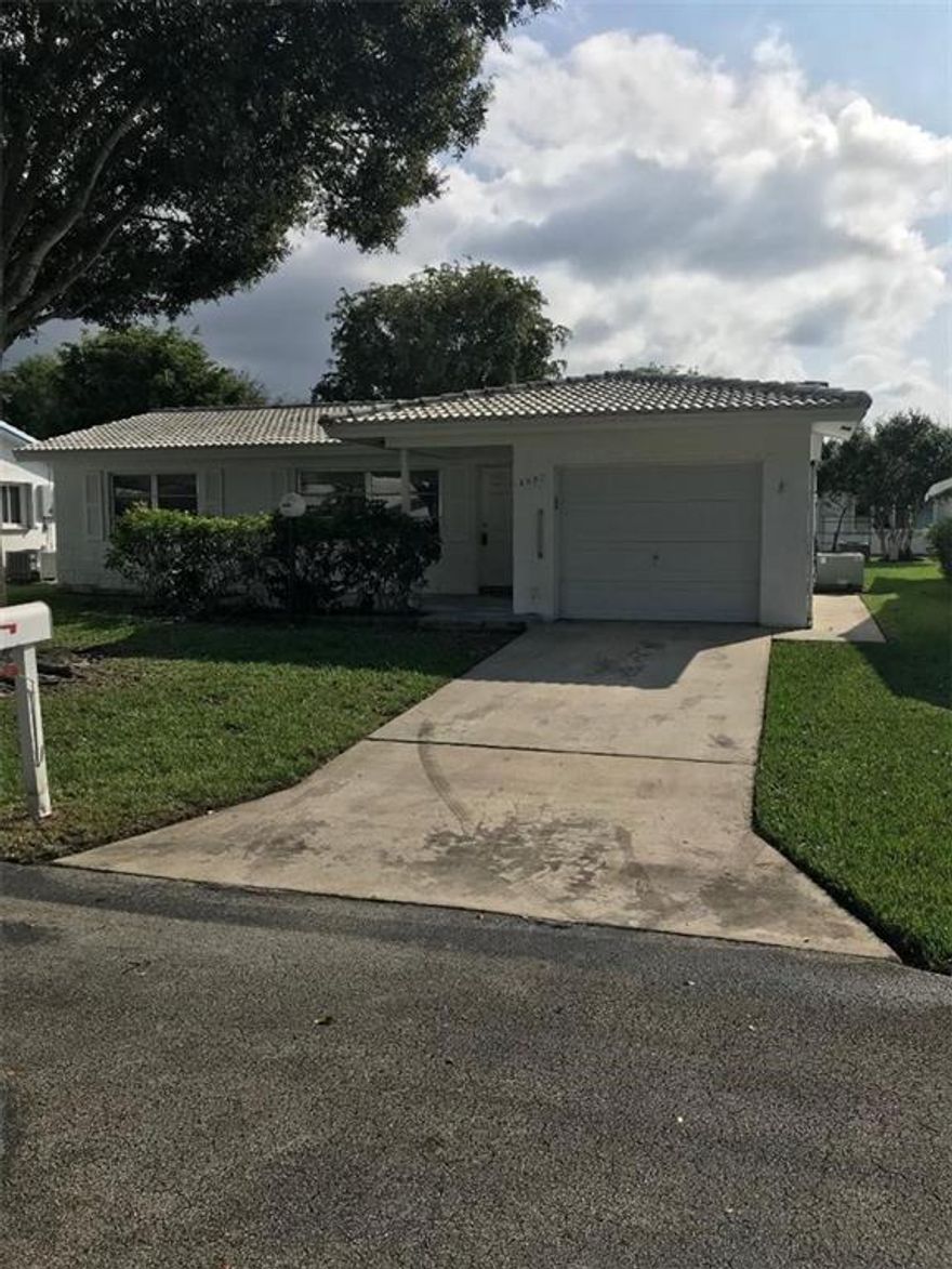 Own in Plantation Where the Grass is Greener! This Lauderdale West Home Rarely comes available and is one of the largest homes in the community.  It is a Rare 3/2 and can be turned back into a legal 3 Bedroom 2 bath House! Listed as a 3/2 making it one of the largest homes and most desirable in Lauderdale West.  The Home offers large windows, tons of natural light, an open kitchen, and ceramic tile throughout.  Come to see this great home before its Sold!  This is 55+ verified and HOA maintains lawn, exterior maintenance, insurance, and Community Club house and pool