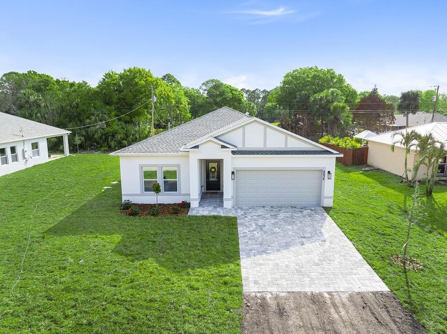 Brand new 2026 Palmetto model by HDZ Homes, a unique builder raising the standard of quality construction in Vero Lake Estates. This thoughtfully designed 3-bedroom, 2-bath CBS home with 2-car garage offers a bright open-concept layout centered around a spacious great room perfect for everyday living and entertaining. Interior finishes include luxury white oak LVP flooring throughout, quartz countertops, shaker-style cabinetry, stainless steel appliance package, and an oversized kitchen island with seating. The private primary suite features a large walk-in closet and spa-inspired bath with dual vanities and glitzy designer wall tile shower creating a high-end luxurious feel without cutting corners. Guest bath also features striking tile work and upscale finishes. A spacious laundry room with utility sink cabinet, modern lighting, and contemporary hardware add both function and style. Enjoy outdoor living on the covered porch plus attractive paver driveway and entry walkway. Built with durability and efficiency in mind, the home includes impact windows and CBS construction. Buyers also benefit from a transferable builder and structural warranty for added peace of mind. A rare opportunity to own a stylish, quality-built new home by one of the most distinctive builders in Vero Lake Estates.