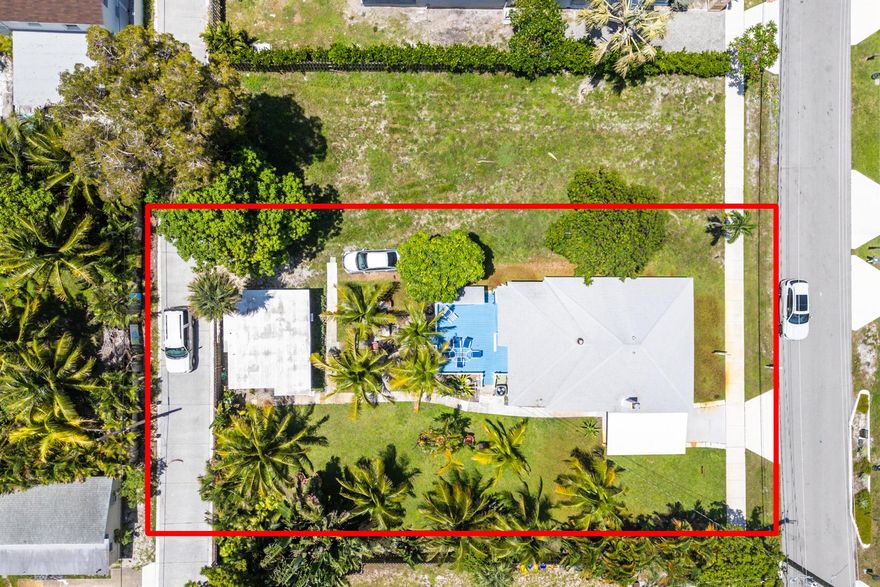 Build a TROPICAL Estate  only 2 blocks from ATLANTIC AVENUE - 10,500 square foot lotThis Osceola Park GEM is unique with extra large lot and a Paved alley in back - allowing private access to driveway - Build a 4,000 plus Sq ft. estate with a 3-car garage and apartment above. Currently on property is a CHARMING totally updated 2/2 100 year old home, hardwoods floors, light and bright kitchen and baths, screened patio, large back porch and an updated guest cottage with 1/1 quaint living space.  Both furnished and highly desirable SEASONAL RENTALS - taking in 15k per month