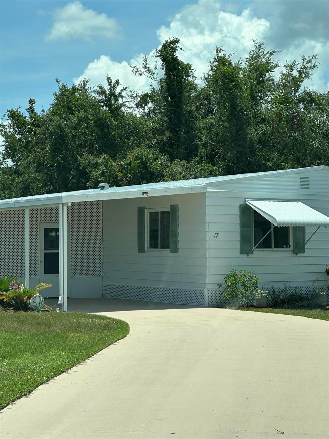 Large Lake View home with inside laundry, two dining areas, Huge living room, Florida room as well as a screened patio, Extra large shed in the back of the home, laminate flooring, large kitchen, extra long driveway in the cul-de-sac not far from the clubhouse and pool, boat ramp and day dock available to the residents right on the North Fork of the St. Lucie River. Don't miss this one, buyer responsible for verifying all information. Selling as-is