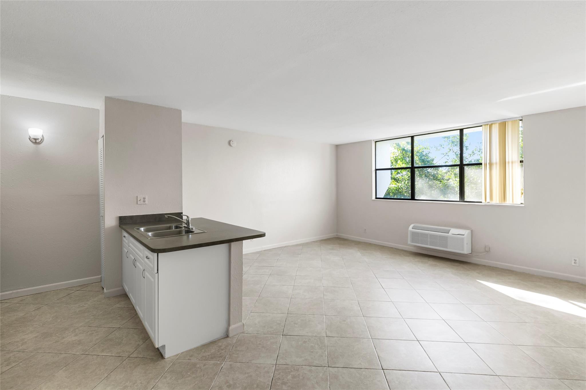 Top floor corner unit studio apartment/condo in the heart of Coral Springs. Freshly painted, Tile flooring, a walk-in closet, & NO popcorn on ceilings. Kitchen features a large counter-top & New Stove. New Roof on building. Close to major highways and roads, close to parks and shopping. Secured Building. Laundry facilities in the building. Pool. Great opportunity for investment. Unit can be rented right away. LOCATION & PRICE CAN'T BE BEAT! Don't miss out! Pets allowed.