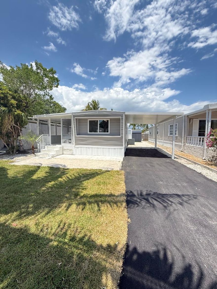 Move in turn key  completely remodeled  3 bed 2 bath mobile home!  No land lease, you own the land! This home features brand new luxury vinyl flooring throughout, brand new modern tile in the bedrooms and bathrooms. Large and spacious open floor plan perfect for entertaining! Brand new carport installed, brand new stainless steel appliances and washer/dryer in shed.  Large covered porch for relaxing and brand new double pane windows throughout the home. This community is perfect for Florida lifestyle, amenities include large heated pool, clubhouse, hot tub, fitness center, golf course, tennis pickleball, BBQ area, bowling, lake with boat ramp, beach area,on site cafe. Just 4 MILES FROM THE BEACH and minutes from DANIA POINTE, OAKWOOD PLAZA, the HARD ROCK CASINO, and top dining options.