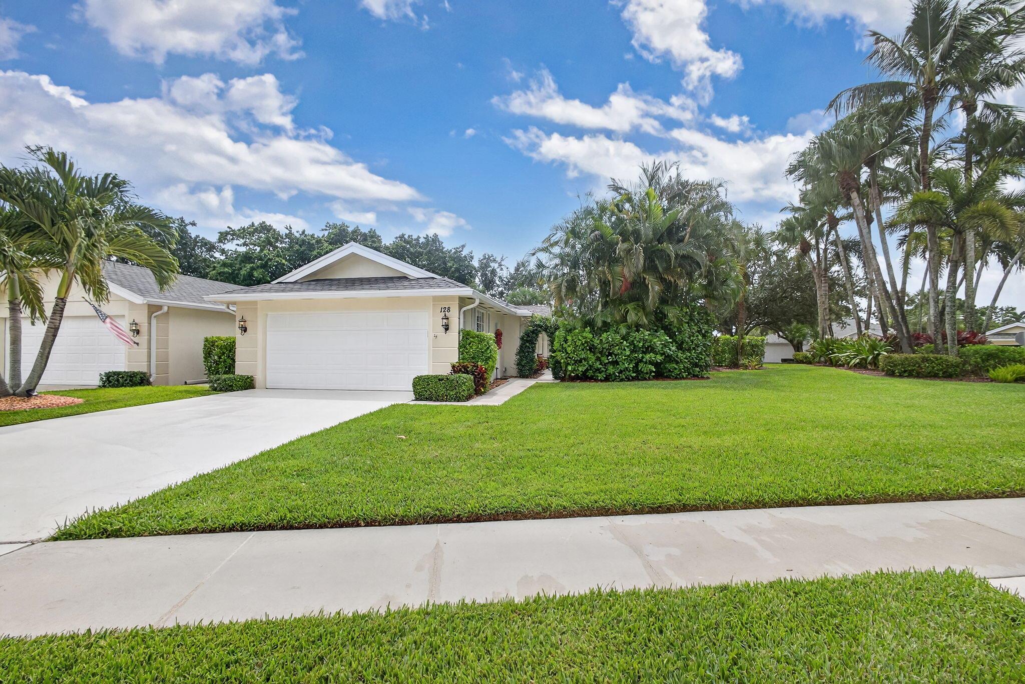 RARE OPPORTUNITY to own a beautifully updated DiVosta Capri model on one of the largest lots in Greenbrier at the Indian Creek golf course community. One of a kind end unit with an extra large side lot, glistening pool, lovely garden, and brick patio area. 360 degree views of bright blue Florida skies with mature palm trees, oaks, flowering trees, and breathtaking sunsets. Lives like a single family home with all the conveniences and quality of a single level, low maintenance villa. Come inside the uniquely private entrance to a beautifully remodeled oasis with uniform tile floors throughout every room. The upgraded kitchen boasts soft close white custom cabinetry, light granite countertops, stainless steel appliances, upgraded fixtures and lighting.