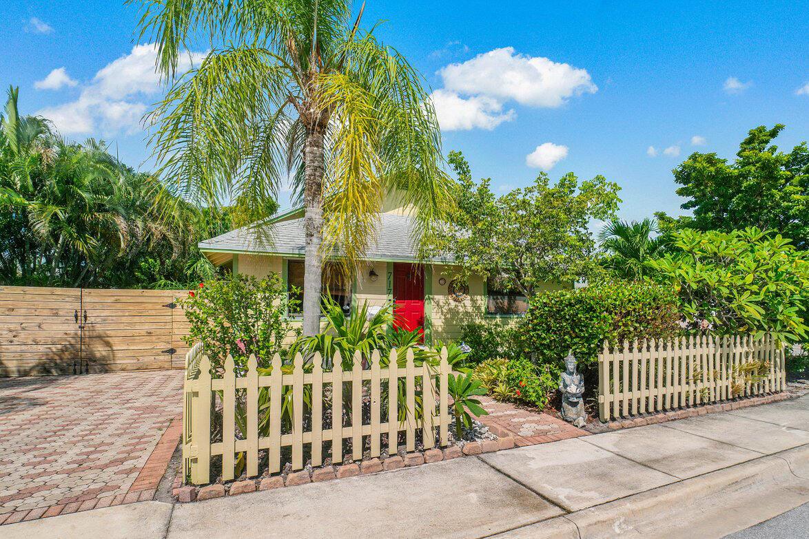Charming, historic 2bd/1.1ba bungalow nestled on a quiet, one-way street in the vibrant Lake Worth Cottages community. The interior has been meticulously maintained and includes a new powder room, 2019 gas tankless water heater and 2024 A/C. The 6,750 sqft lot is a fully fenced outdoor sanctuary with a 350 sqft oversized screened porch built in 2020, new outdoor shower with hot water, an abundance of native plants and trees including mango, gumbo limbo, mamey and more. New roof installation contracted to begin August 2025. Room for a pool and zoned two-family residential for potential mother-in-law suite. Ring doorbell, HomeSafe security alarm and transferable termite bond provide peace of mind for the homeowner.