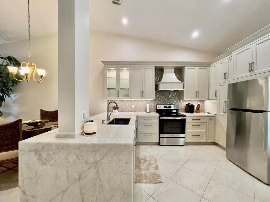 Beautifully remodeled furnished condo in Meadowbrook at PGA National. Stunning kitchen update with full overlay cabinets and cristallo quartzite waterfall counters. Inviting spacious Great room with cathedral ceilings and sliding glass doors that lead to a relaxing screened balcony.  Large Primary bedroom with walk-in closet and updated baths. Luxury vinyl floors, paddle fans and cozy, comfortable furnishings adorn this light and bright, immaculate condo. Steps to the community pool. Meadowbrook at PGA National is minutes to all the shopping and casual & fine restaurants along PGA Blvd, 15 minutes to the warm, sunny beaches, and PBI Airport. Beautiful condo, perfect location, great value.