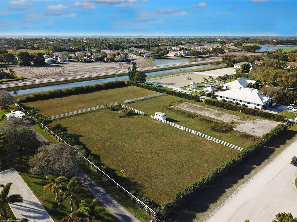 Reduced $175,000! Location, location, location! Just minutes to WEF Showgrounds by horseback or car! Improved 2.01 acre lot backing to bridle path to Pierson Road, offering easy access to the showgrounds. The lot has been cleared, filled and fenced. An irrigation pump has been installed with the water supply coming off of the canal. Surrounded by beautiful farms and located across the canal from the new Winding Trails equestrian subdivision. All of Wellington's international equestrian competition venues for polo, dressage and jumping are just minutes away. If you're looking to build, this is a prime location for your investment cannot be beat.