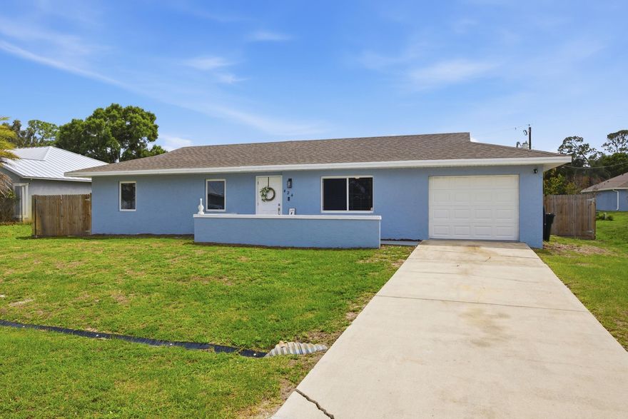 The Sunshine State is calling and this MOVE-IN READY, 3-bedroom, 2-bathroom home in Port St. Lucie is ready for you to answer!  Built with solid CBS construction and featuring impact windows and doors throughout, this home offers peace of mind with major updates already completed, including a 2021 roof, 2024 fence, 2025 AC, 2025 water heater!  Inside, you will find a clean, well-maintained interior with no carpet, making it both stylish and easy to care for. The kitchen is equipped with upgraded appliances and flows seamlessly into the main living areas, creating a comfortable space for both relaxing and entertaining.   Step outside to a spacious screened-in patio, perfect for enjoying Florida evenings, and a fully fenced backyard with plenty of room to create your own outdoor oasis, whether that includes a pool, play area, or garden.  Ideally located near shopping, dining, schools, and parks, this home is a fantastic opportunity for a small family, first-time buyer, retiree, or investor looking for a solid, move-in ready property.