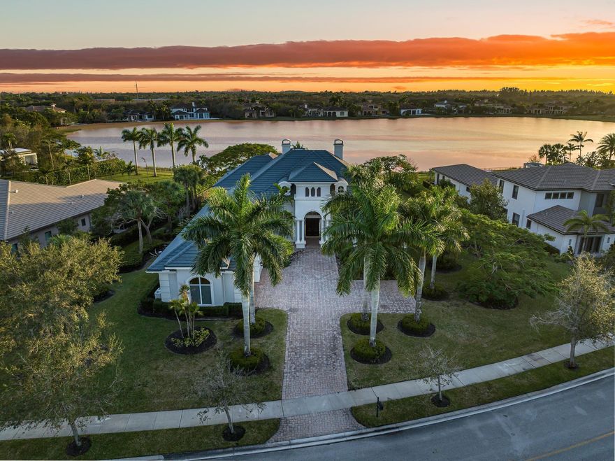 Stunning single-story estate in prestigious Windmill Reserve, offering sweeping panoramic lake views. This elegant home features 5 bedrooms plus an office, 7.5 bathrooms, and refined marble flooring throughout. The grand living room impresses with soaring ceilings and a fireplace. The luxurious owner’s suite is a private retreat with spa-style bathrooms and spacious walk-in closets with custom built-ins. The chef’s kitchen is appointed with rich wood cabinetry, a gas cooktop, and premium Wolf and Sub-Zero appliances. Designed for seamless indoor-outdoor living, the home features a spacious patio, oversized pool with spa, and summer kitchen with barbecue. Additional highlights include a 3-car garage, smart-home upgrades, and a 0.83-acre lot in one of Weston’s most exclusive gated enclaves.