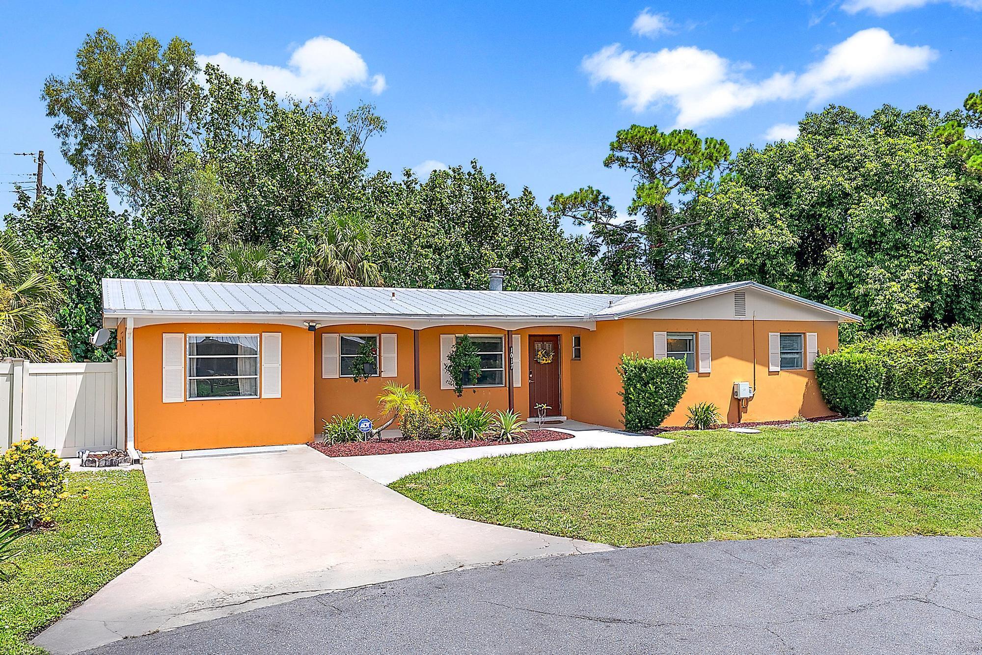 Tucked away at the end of a peaceful, tree-lined street, this charming 3-bedroom, 2-bath concrete home is conveniently located just a few minutes from charming downtown Stuart & some of the area's most beautiful beaches. Highlights of this home include the durable LVP flooring throughout, a newer metal roof, updated A/C (2023), & a freshly painted interior! The inviting living area boasts a wood-burning fireplace, perfect for cozy evenings. Just off the kitchen, you'll find a versatile flex space, ideal as a den, home office, or creative studio. The large screened lanai provides a perfect spot for relaxing and entertaining, overlooking a private fully-fenced backyard. The large air-conditioned shed awaits your vision- Transform it into a she-shed, man cave, or keep it ready for project.