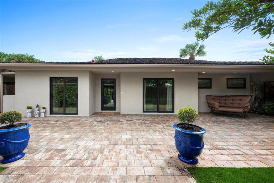 Welcome home to 11683 Wimbledon Circle, located in the desirable East Lake Bungalows of Palm Beach Polo Club. Meticulously renovated from floor to ceiling, this property features a 3-bedroom, 3-bath main house complemented by a charming detached 1-bedroom, 1-bath suite--together offering 2,170 sq ft of elegant, tailored living space.Step inside to beautiful porcelain tile floors and vaulted open-beam ceilings. Sliding glass doors span the dining and living rooms, flooding the space with natural light and tranquil views of East Lake and its fountain.The custom kitchen boasts sleek stainless steel appliances, contemporary quartz countertops with matching backsplash, and dedicated bar seating. A full-size washer and dryer are artfully tucked out of sight.