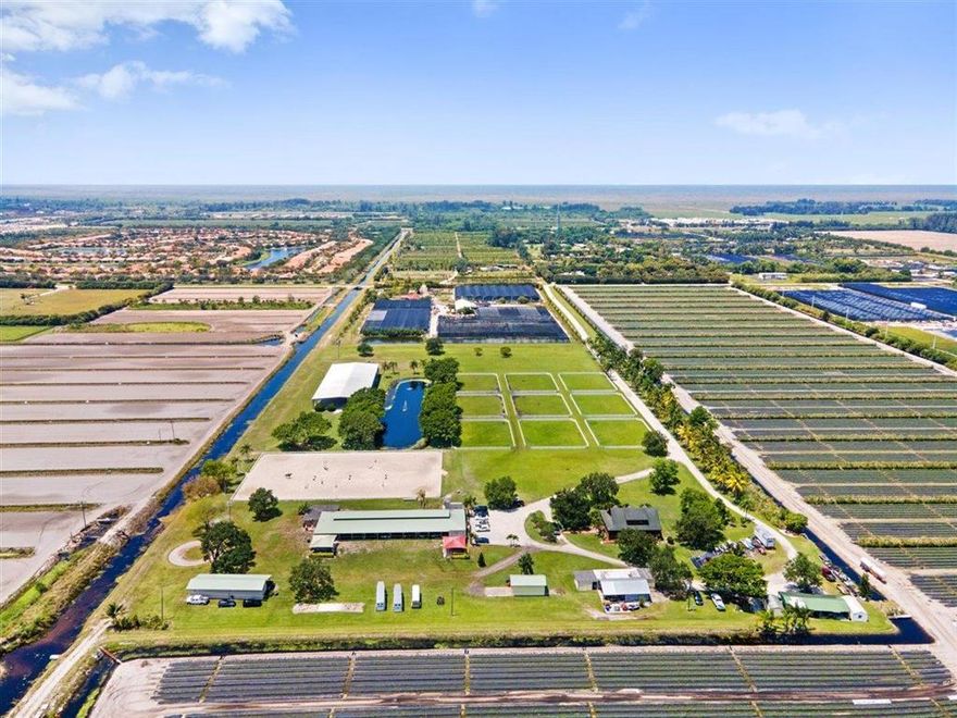 Location, Location, Location!! This  sprawling 17+ acre Delray Beach equestrian compound has it all. A long private driveway leads to three barns offering 20 + stalls. There is a large sand arena adjacent to the main barn and, just beyond, is a 100'' X 220' covered arena with mirror wall. The grass jump field is just beyond the covered arena and the 9 oversized irrigated paddocks. The 3 bedroom grooms quarters is located at the main barn. There is a 3 bedroom log cabin home located in the left rear corner of the property with a 4 bay equipment shed in the rear.. There is a strong stall rental business with documented history. Truly a Must See Property!!