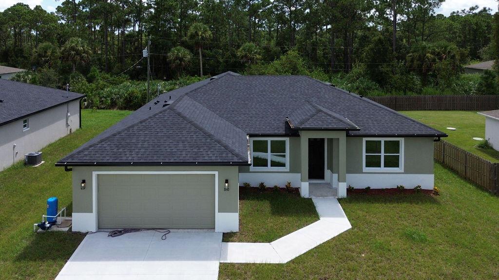 Welcome to Palm Bay, where growing neighborhoods and a relaxed coastal vibe make this city one of Florida's hidden gems. This brand-new home offers 1,926 sq. ft. of modern living space with 3 bedrooms and 2 baths, perfect for families or first-time buyers. Enjoy elegant LVP flooring, 9- and 10-foot tray ceilings, and a split-bedroom layout that balances privacy and connection. The open living area leads to a spacious covered patio, ideal for weekend barbecues or quiet evenings. With hurricane impact windows and the advantages of new construction, this home combines style, safety, and the fresh start you've been looking for in beautiful Palm Bay. *Professional Photos Coming Soon*