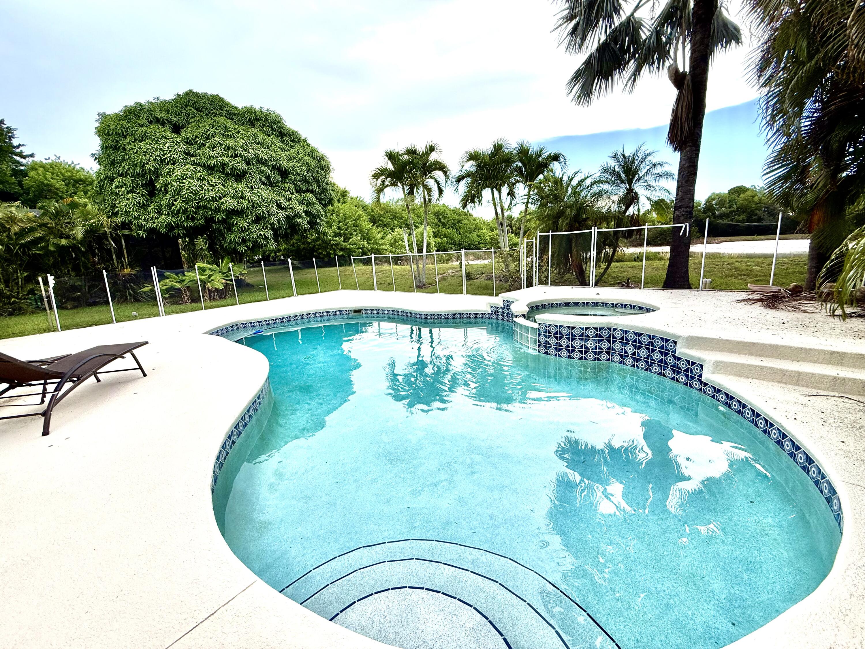 Prime Location in The Pines - Pool Home East of US1! Ideally situated in the highly sought-after community of The Pines, just east of US1 and minutes from pristine beaches, top-rated schools, shopping, and dining. This elegant home features a smart split-bedroom floorplan and a well-equipped kitchen perfect for both daily living and entertaining. The expansive screened pool area overlooks a peaceful pond/lake, offering the perfect combination of comfort, style, and natural beauty