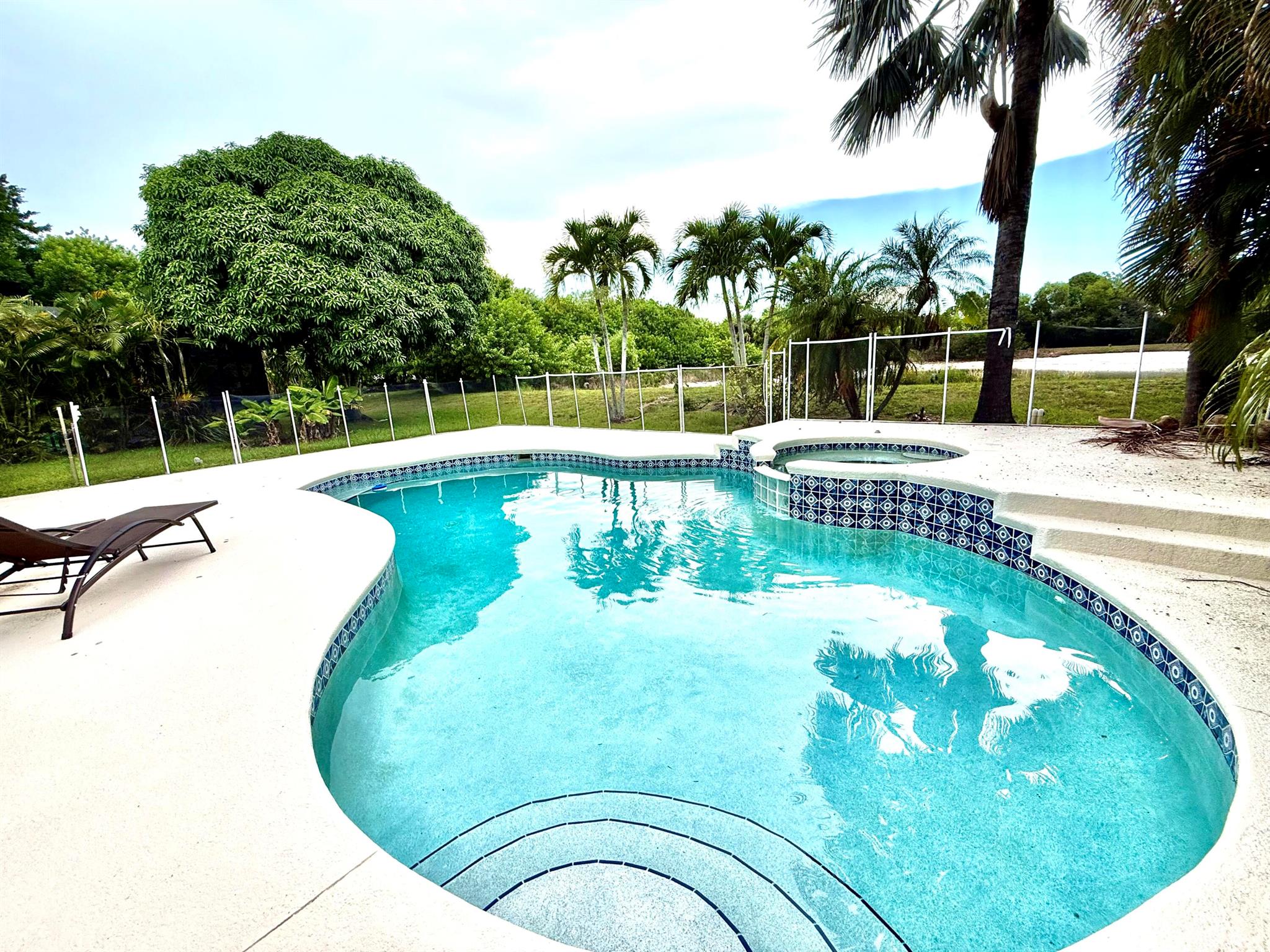 Prime Location in The Pines - Pool Home East of US1! Ideally situated in the highly sought-after community of The Pines, just east of US1 and minutes from pristine beaches, top-rated schools, shopping, and dining. This elegant home features a smart split-bedroom floorplan and a well-equipped kitchen perfect for both daily living and entertaining. The expansive screened pool area overlooks a peaceful pond/lake, offering the perfect combination of comfort, style, and natural beauty