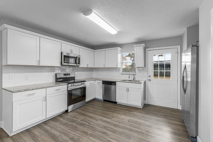 This adorable home is all buttoned up and totally ready for you. From the 2020 metal roof to the 2023 AC & 2025 Water Heater the big ticket items are checked off the list. The cosmetics are taken care of too: fresh interior/exterior paint, a beautiful updated kitchen w/ SS appliances, white shaker cabinetry, subway tile and granite, an updated bathroom w/ a shower/tub combo, new flooring (carpet, tile & laminate), new baseboards, new lighting & ceiling fans and the list goes on and on. The large yard is ideal for pets or gardening and the home even comes with a screened patio & spacious shed!