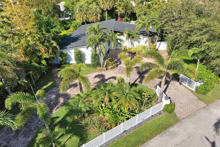 Situated on an oversized 11,526 sq ft lot, this residence is nestled within the exclusive Santa Barbara Estates, less than one mile walking distance to Pompano Beach. Ideally positioned in a rapidly evolving coastal corridor, the home is surrounded by significant luxury development, including the nearby W Residences, Waldorf Astoria, Ritz-Carlton, and Armani Casa. This gated mid-century modern style home offers seamless indoor-outdoor living, with glass doors opening to a large private backyard oasis featuring lush gardens, a pool, and spa. Additional highlights include a two-car garage and recent upgrades such as a new roof (2025) and all impact windows and doors, offering enhanced comfort, security, and long-term value.