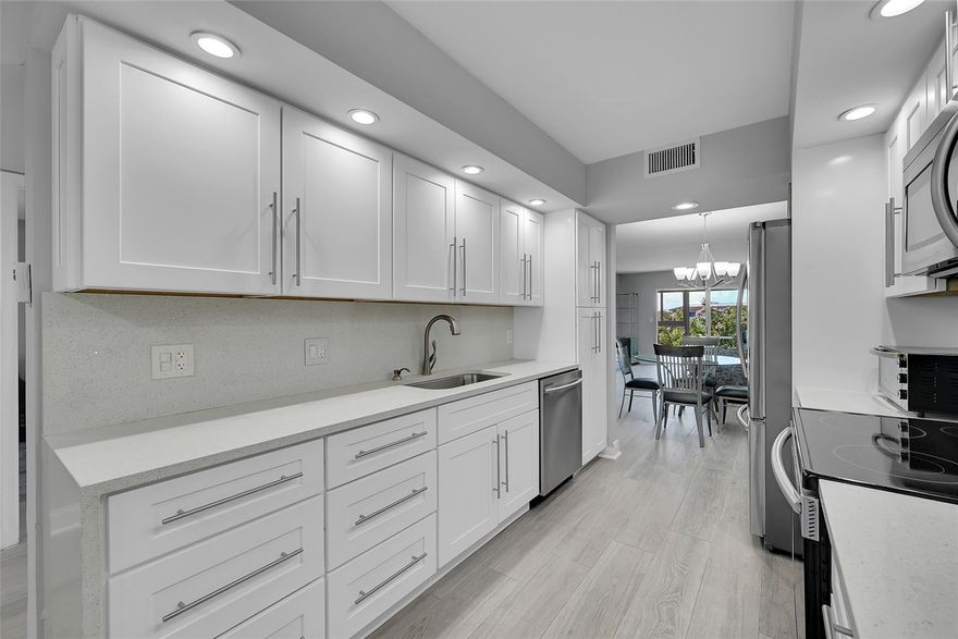 Live the ultimate luxury lifestyle in this exquisite 2BR/2BA gated residence, fully redesigned to perfection. Enjoy breathtaking lake and fountain views through floor-to-ceiling hurricane impact glass. The open layout features porcelain wood plank floors, a chef’s kitchen with Samsung stainless appliances, waterfall quartz counters, and designer backsplashes. Spa-like baths boast frameless showers and floor-to-ceiling tile. Custom walk-in California closets, smooth ceilings, crown moldings, and newer electric, plumbing, A/C, and water heater make this a true move-in-ready gem. Washer/Dryer in the unit and Nothing left untouched. The amenities are Bar none with Community club house, shows, exercise classes and so much more.