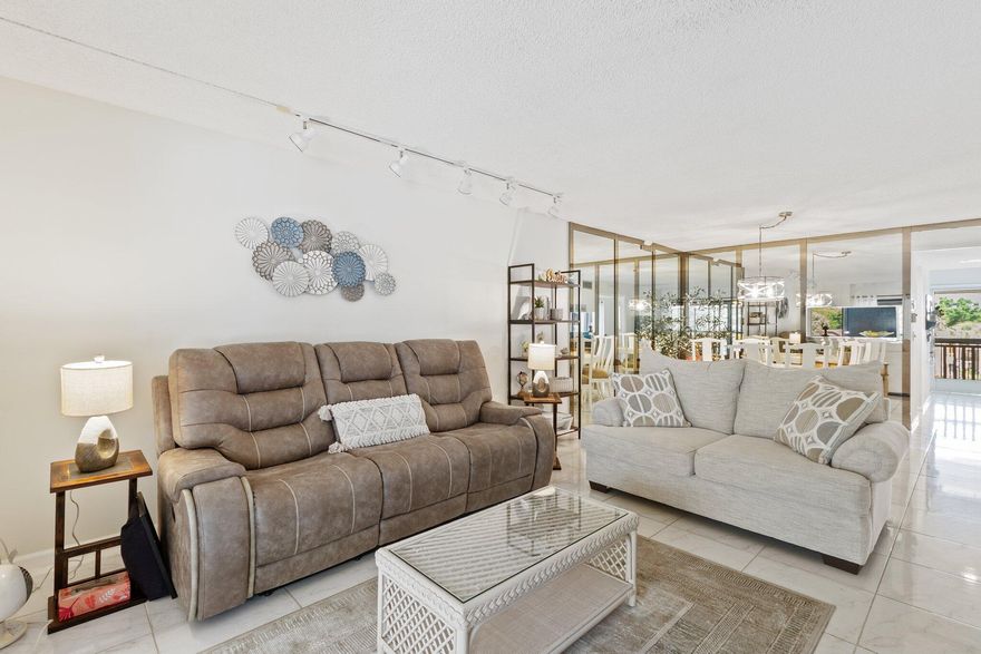 Imagine living each day in your NEWLY Remodeled Open Kitchen,  lake views and ending it with glowing sunsets from your own private retreat. This spacious 2-bedroom, 2-bath condo invites you into resort-style Florida living within the vibrant 55+ community of Banyan Springs. Designed for comfort and ease, the home offers a bright kitchen with a sunny breakfast nook, a serene primary suite with double-door entry and calming water views, and a screened lanai where morning coffee and evening wine become daily rituals. Beyond your front door, Banyan Springs delivers a true resort experience—enjoy a clubhouse café, arts and social gatherings, tennis and pickleball courts, two resort-style pools, and a full calendar of activities. Here, life feels relaxed, connected, and effortlessly enjoyable.