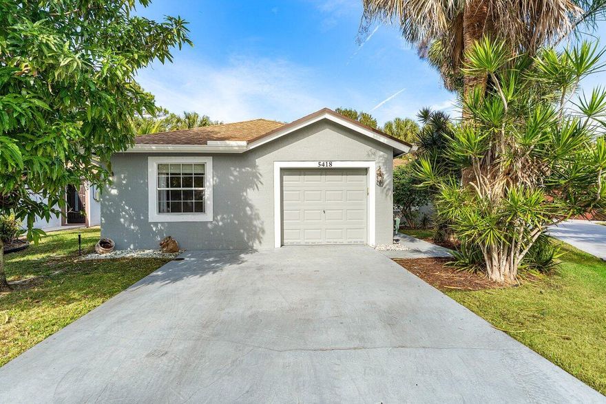 Experience your own piece of Florida tropical living, surrounded by lush landscaping including mango trees, red ginger, palms, canna lilies, and clusia in a generously sized backyard. This bright and spacious 3-bedroom, 2-bath home showcases soaring vaulted ceilings, elegant crown molding, recessed lighting, and a beautifully open floor plan designed for comfortable living and easy entertaining. The kitchen features rich chestnut-brown cabinetry, granite countertops, and stainless-steel appliances, creating a stylish and functional space for everyday meals or hosting guests. The spacious primary suite offers a walk-in closet and a desirable split-bedroom layout that provides added privacy from the additional bedrooms.  Step outside to enjoy tranquil outdoor living on the screened-in patio overlooking lush green space with no rear neighbors. Located in a quiet, hidden-gem neighborhood in the Town of Haverhill, the home is just minutes from Downtown West Palm Beach and Wellington. A peaceful park with a walking trail is only steps away. Low HOA fees include landscaping, making it easy to enjoy the beauty of the community without the upkeep.