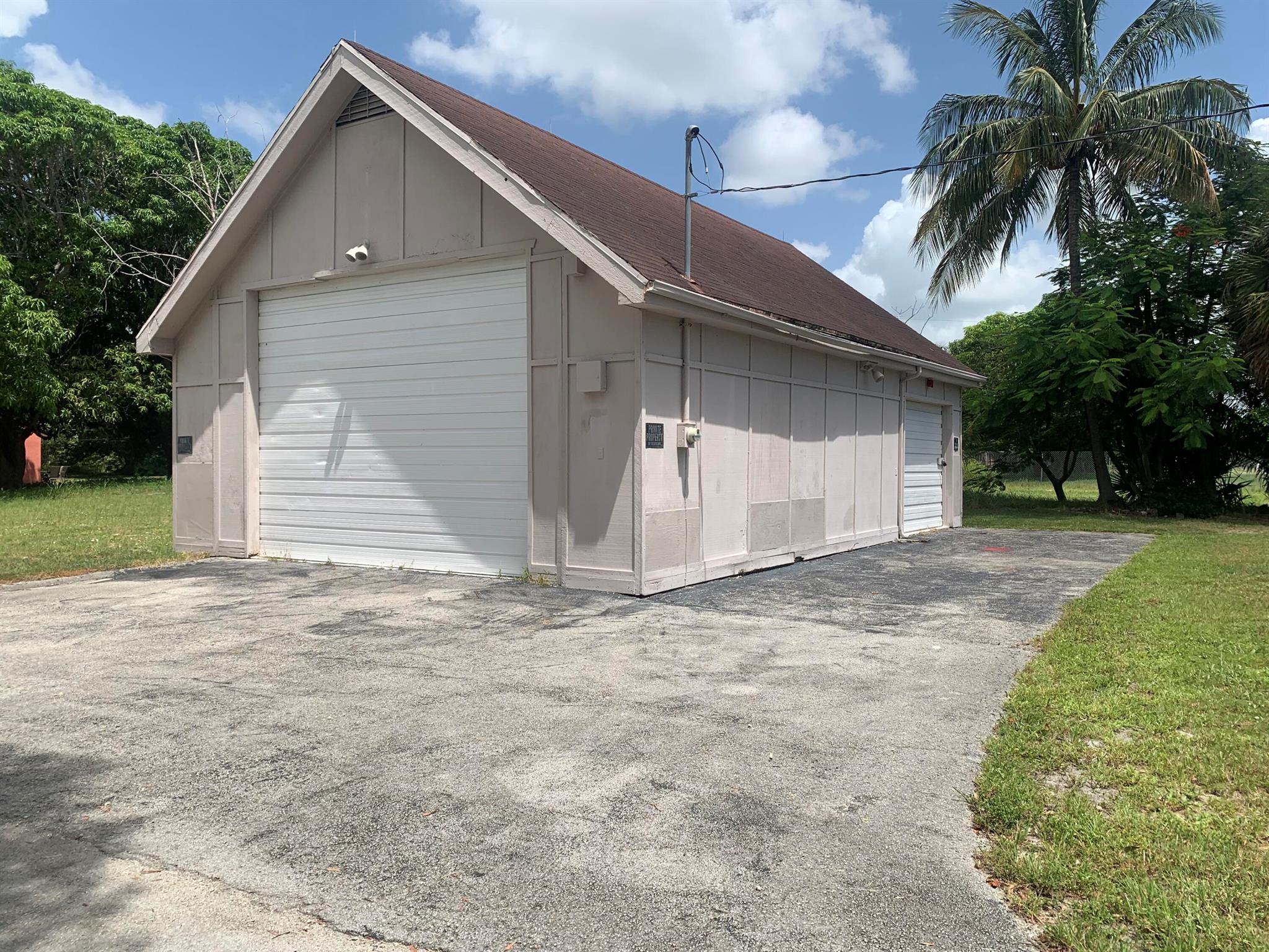 Free standing building 4 car garage (25' x 38') with 2 overhead doors and an upstairs storage loft area and all on a beautiful corner lot