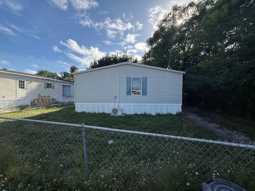 Tucked away at the end of a quiet cul-de-sac, this recently upgraded 4 bedroom manufactured home offers privacy on an oversized lot surrounded by natural foliage truly giving the feeling of living in your own peaceful woodland retreat. The spacious great room welcomes you with a charming rustic fireplace, creating the perfect setting for relaxing evenings or gathering with family and friends. The home's thoughtful updates enhance both comfort and functionality, making it move-in ready. Step outside to a huge, fully fenced backyard, ideal for entertaining, play, pets, or simply enjoying the serenity of nature. With no rear/side neighbors, a level of tranquility and space that's hard to find. A unique opportunity to enjoy privacy, space, and a warm,  inviting home in a truly special setting