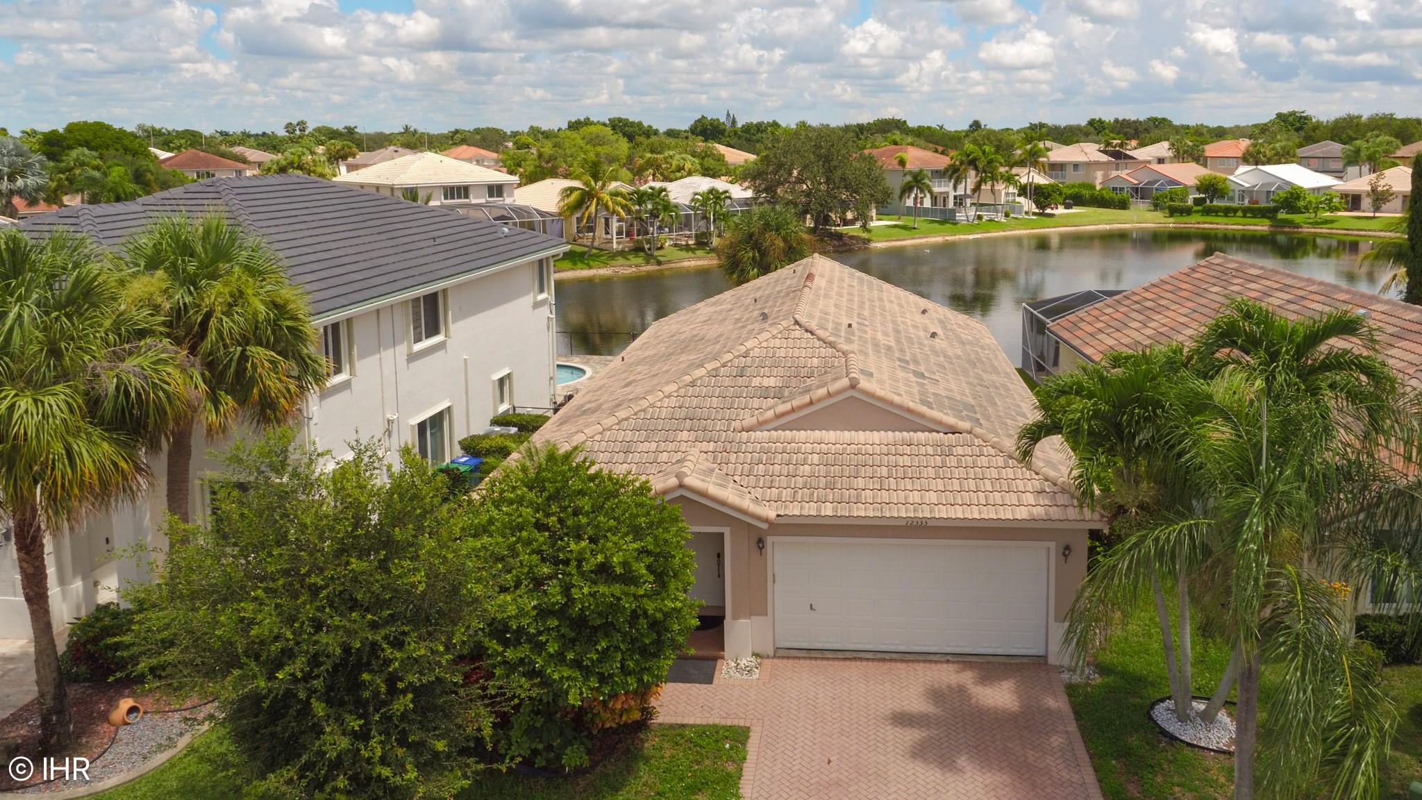Seeing is Believing! This 3/2 home in the gated community of Wyndham Lakes is the perfect place to relax and unwind. Large, gorgeous lake view with wonderful pool, so there are no neighbors behind you. The house feels light, bright, and open with lots of glass windows offering views of the pool and lake. The kitchen has stainless steel with granite countertops. It is next to the family room, making it desirable for entertaining. The Master Bedroom includes a private bathroom with a huge walk-in shower. There is a dedicated laundry room with a two-car garage. HOA is low. Also, the elementary school, middle school, and high school are all top-rated schools. Close to Sawgrass, major highways, restaurants, and stores. Has accordion shutters. The neighborhood has sidewalks for walking.