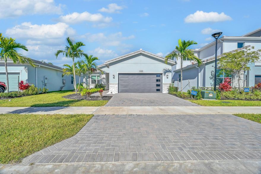 Beautiful lake views and well-maintained 3 bed, 2.5 bath, with home office available for rent in Tradition inside the desirable community of Seville. This newer construction property offers an open and functional floor plan. The home features a spacious great room, a modern kitchen with an oversized island and stainless steel appliances, and a designated dining area. The primary suite includes a walk-in closet and an ensuite bathroom with dual vanities and a walk-in shower. The split bedroom layout provides privacy. . Impact windows throughout the home offer added safety and energy efficiency. A covered lanai overlooks the backyard providing a comfortable outdoor area.