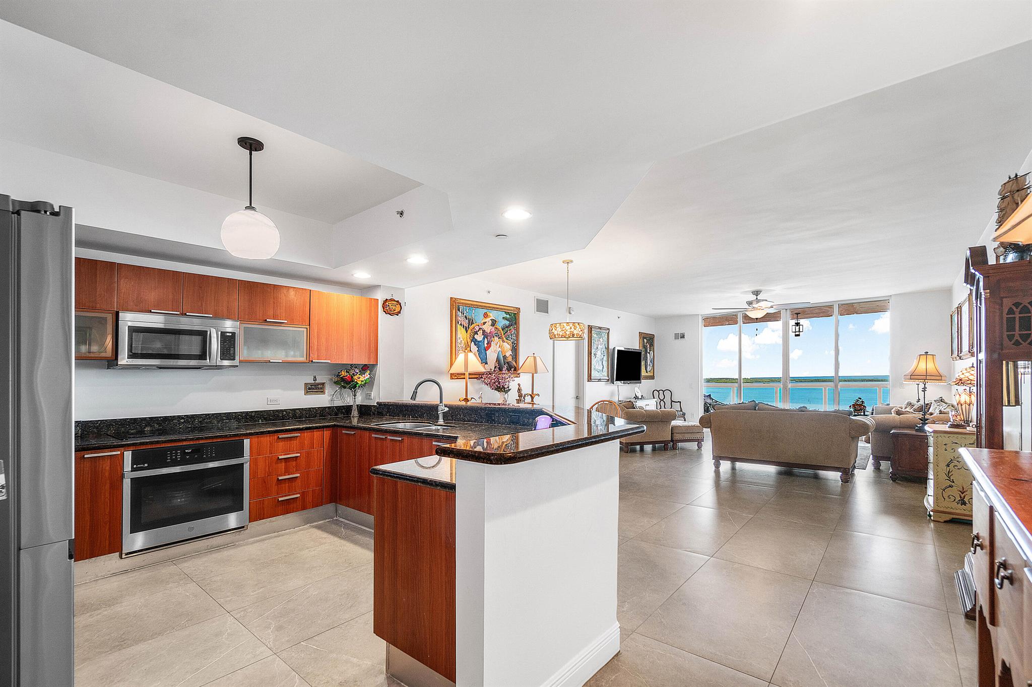 Experience luxury coastal living in this 17th-floor gem at the highly sought-after Marina Grande Condos! This beautifully maintained residence boasts a brand-new central A/C (July 2025), 3-year-old appliances, and tile floors throughout, including marble tile in the owner's suite--no carpet in sight!The spacious owner's suite features two walk-in closets, dual sinks, and an LG tower washer & dryer for ultimate convenience. Wake up to breathtaking Intracoastal views and enjoy being just minutes from the beach and Peanut Island.Resort-style amenities include a new rooftop pool, tennis & pickleball courts a fitness center with steam room & sauna