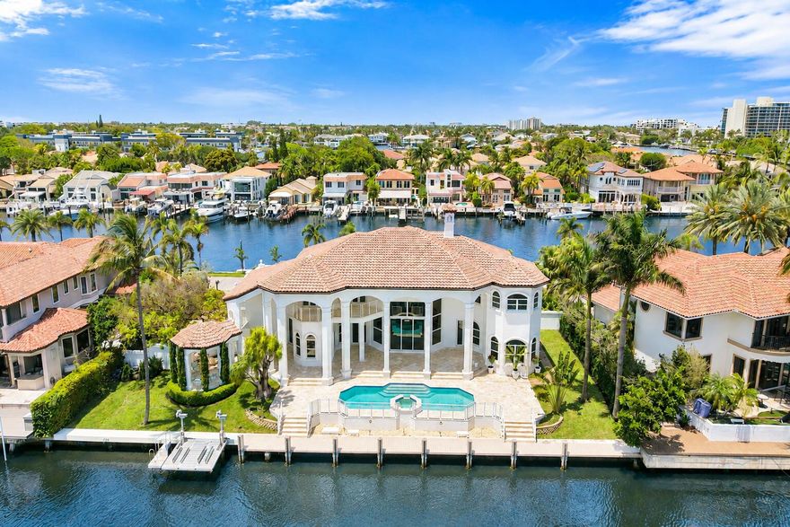 Experience waterfront living at its finest in this beautifully reimagined custom estate in Tropic Isle South, one of Boca Raton's most exclusive gated enclaves. Perfectly positioned on a rare double waterfront lot with 300 feet of deepwater frontage- 150 feet on each side of the property- and including a brand new seawall on the north side, this residence captures sweeping and grand canal views from every room.  Currently undergoing a full interior and exterior renovation and expected to be completed by April, this home will feature a brand-new designer kitchen with dual islands, a walk-in pantry, and top-of-the-line Wolf and Sub-Zero appliances, creating the ultimate culinary haven. The impressive open layout is complemented with all new Hurricane impact windows and sliders, soaring ceilings and custom architectural details that flood the interiors with natural light. Each of the 4 spacious bedrooms is en-suite, complete with its own private bath and closet. The home offers two luxurious primary suites--one on the main level and another upstairs--ideal for multi-generational living or guest accommodations.  Step outside to enjoy extensive outdoor living spaces, including a covered patio, a fully equipped summer kitchen, two covered balconies, and a gazebo overlooking the water. A 3-car garage provides ample parking and storage, perfectly complementing the home's thoughtful design and functionality.  Located minutes from vibrant dining and shopping in Downtown Boca Raton and Delray Beach, this one-of-a-kind property offers the best of South Florida's luxury living. Expected completion April of this year.