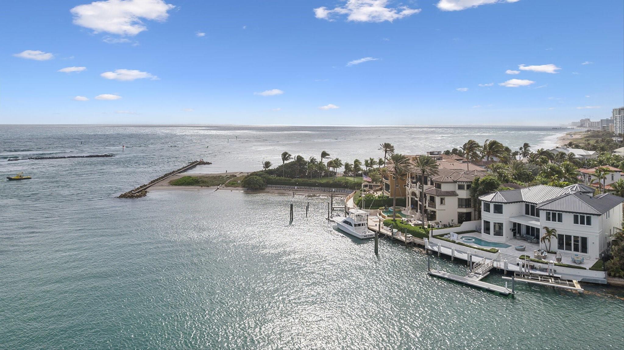 Enjoy luxury waterfront living in this stunning custom home, offering breathtaking views of the Hillsboro Inlet, the iconic & historic Hillsboro Lighthouse, and the Atlantic Ocean. Spanning 6,663 square feet, this exquisite residence features 5 bedrooms, 4.5 bathrooms, a functional office, a cozy loft, a wine cellar, and a charming craft room. Built in 1998 and remodeled in 2016, the home boasts an open floor plan with top-of-the-line appliances and finishes. The expansive outdoor area includes a pool and spa, perfect for entertaining with incredible views. Enjoy 100 feet of water frontage with cement and floating docks for up to three vessels, with a boat lift. Two garages can accommodate up to 5 vehicles. Modern living meets coastal elegance in this exceptional residence.