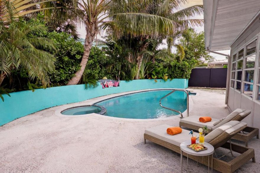 Updated 3BR/2BA mid-century pool home in the sought-after waterfront community of Hypoluxo Shores, just steps from the Intracoastal. This single-story home features a split floor plan, open living spaces, and a Florida room overlooking a private tropical backyard. Recent upgrades include impact windows and doors (2022), new roof (2023), and new HVAC (2024). The kitchen offers granite countertops, stainless steel appliances, and ample storage, with laminate flooring throughout the main living areas. Enjoy a fenced backyard with a heated pool, spa, and lush landscaping, perfect for relaxing or entertaining. Quiet dead-end street location close to beaches, shopping, dining, and major highways. Move-in ready with all major updates completed. Great investment unit to add to your portfolio or even Airbnb for Short Term Stays!