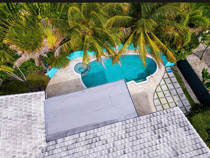 Updated 3BR/2BA mid-century pool home in the sought-after waterfront community of Hypoluxo Shores, just steps from the Intracoastal. This single-story home features a split floor plan, open living spaces, and a Florida room overlooking a private tropical backyard. Recent upgrades include impact windows and doors (2022), new roof (2023), and new HVAC (2024). The kitchen offers granite countertops, stainless steel appliances, and ample storage, with laminate flooring throughout the main living areas. Enjoy a fenced backyard with a heated pool, spa, and lush landscaping, perfect for relaxing or entertaining. Quiet dead-end street location close to beaches, shopping, dining, and major highways. Move-in ready with all major updates completed. Great investment unit to add to your portfolio or even Airbnb for Short Term Stays!