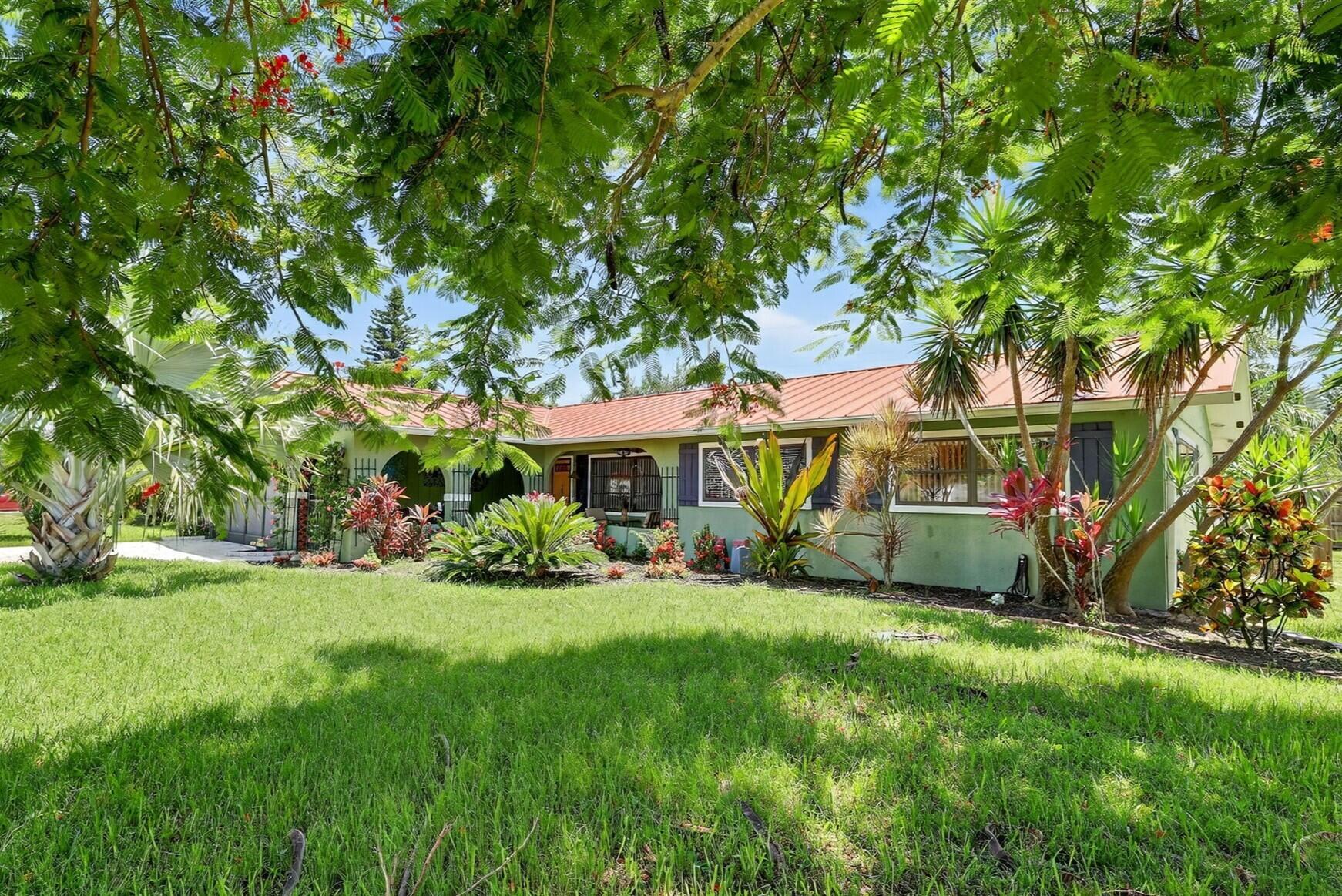 Charming Remodeled Spanish-Style Home with Pool on Oversized Corner Lot! The double gates open onto the welcoming front porch; you'll fall in love with hand-painted details & vibrant colors that perfectly complement the Spanish architecture. This open-concept home offers updated flooring, spacious kitchen, granite countertops, unique hand-painted sinks & showers adding a splash of artisan charm. Formal living & dining rooms flow into a bright & airy Florida room overlooking your tropical backyard oasis. Enjoy relaxing & entertaining under the pergola by the sparkling pool, surrounded by lush landscaping tucked behind a privacy fence. 2 BR + Den/Office, 2 BA, 2-car garage, new metal roof (2021), HVAC (2019), fence (2019). A unique blend of style, comfort, & updates in prime Florida setting