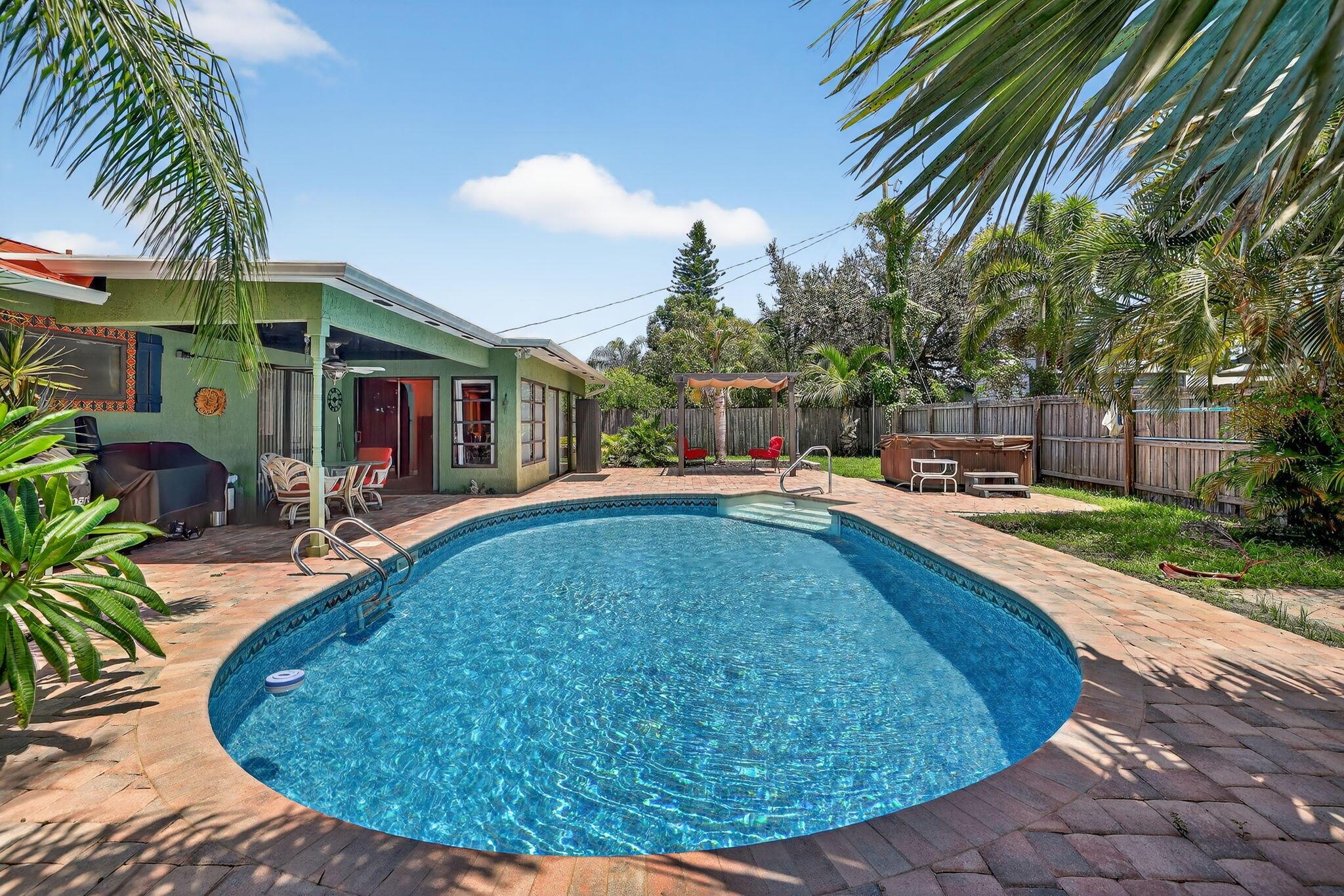Charming Remodeled Pool Home with Pool on Oversized Corner Lot offers a unique blend of style, comfort, & updates in prime Florida setting. Double gates open onto the welcoming front porch; you'll fall in love with hand-painted details & colorful interiors that perfectly complement the Mediterranean style architecture. This open-concept home has updated flooring, spacious kitchen, granite countertops, unique hand-painted sinks & showers adding a splash of artisan charm. Formal living & dining rooms flow into a bright & airy Florida room overlooking your tropical backyard oasis. Enjoy relaxing & entertaining under the pergola by the sparkling pool, surrounded by lush landscaping tucked behind a privacy fence. 2 BR + Den/Office, 2 BA, 2-car garage, new metal roof-2021, HVAC-2019, fence-2019