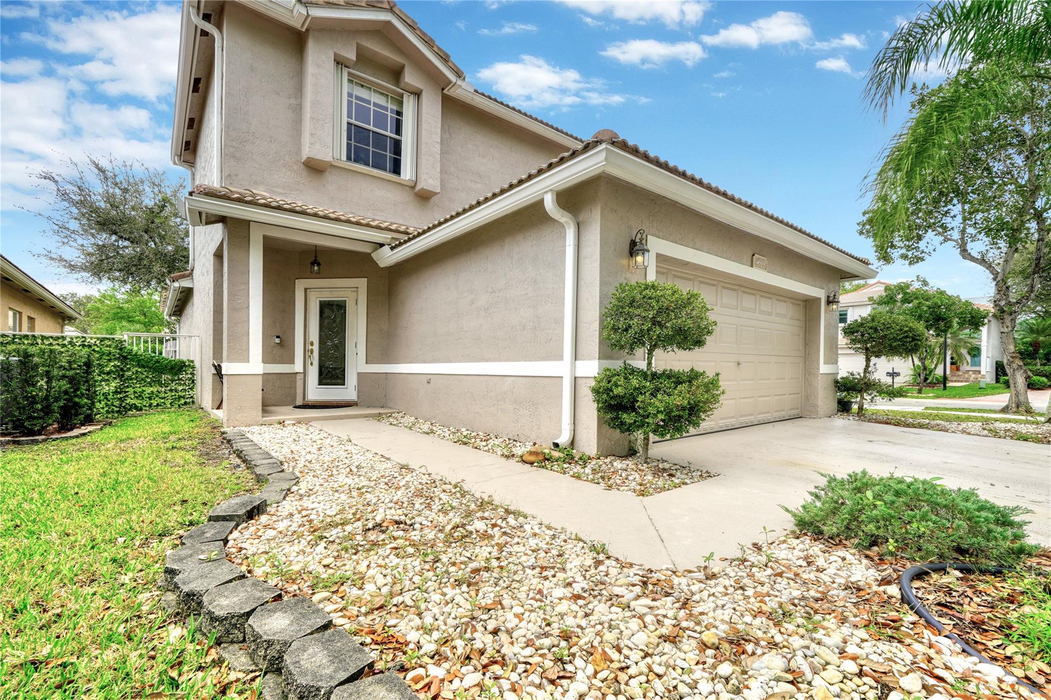 Just Reduced!! Introducing an impeccably maintained 3-bed, 2.5-bath, 2-car garage single-family home in the highly coveted Regency Lakes community of Coconut Creek. Situated on a prized CORNER lot, this residence seamlessly blends contemporary design with functionality. Upon entry, bask in the sunlit great room leading to a spacious kitchen featuring granite countertops, custom cabinets, and stainless steel appliances. The family room effortlessly extends to a tranquil backyard retreat, complete with a custom outdoor kitchen, built-in grill, and a serene rock garden with a fire pit, perfect for entertaining . The ground-floor master suite offers a tray ceiling and walk in closet, while upstairs, a versatile loft/office space adjoins two bedrooms connected by a Jack & Jill bathroom.
