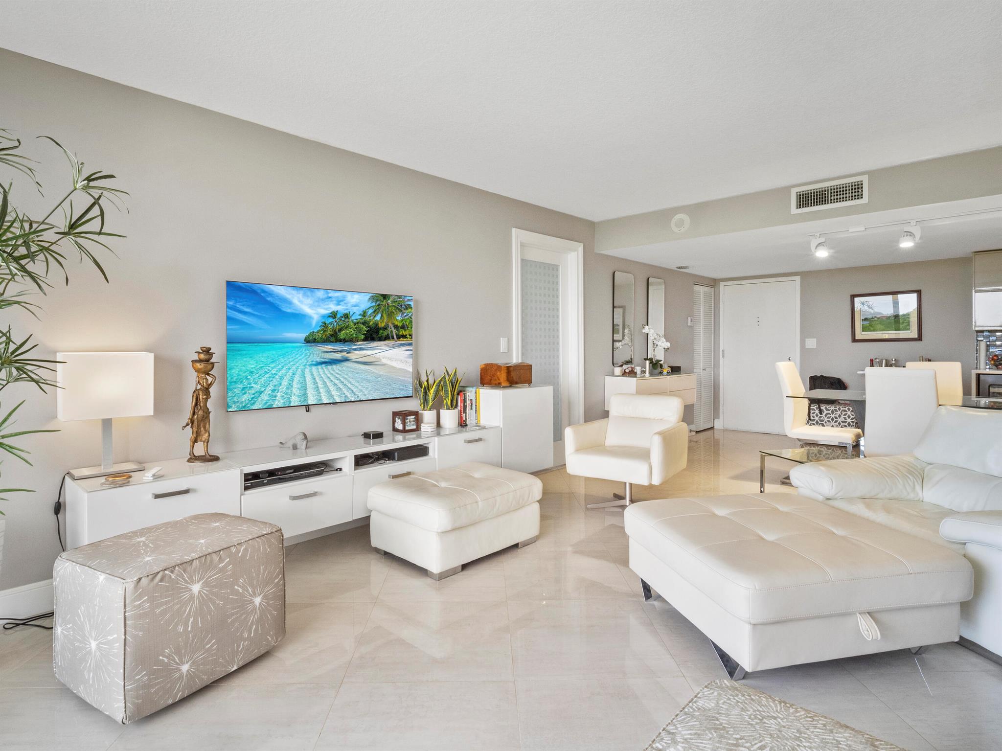 Welcome to this exquisite, fully remodeled 1-bedroom, 1.5-bathroom condo that blends luxury with convenience. The entire unit has been thoughtfully upgraded with premium Italian porcelain tile throughout, creating a sleek, modern atmosphere. The chef-inspired kitchen is a true highlight, featuring top-of-the-line appliances perfect for creating culinary masterpieces.The spacious layout offers seamless flow, and the unit comes fully furnished with stylish, high-quality pieces that make it move-in ready. Enjoy breathtaking views of the serene lake and lush golf course directly from your private balcony or through expansive windows. Additional updates include a brand-new AC system and water heater. Plus, with all assessments paid, this condo boasts one of the lowest HOA fees in the community