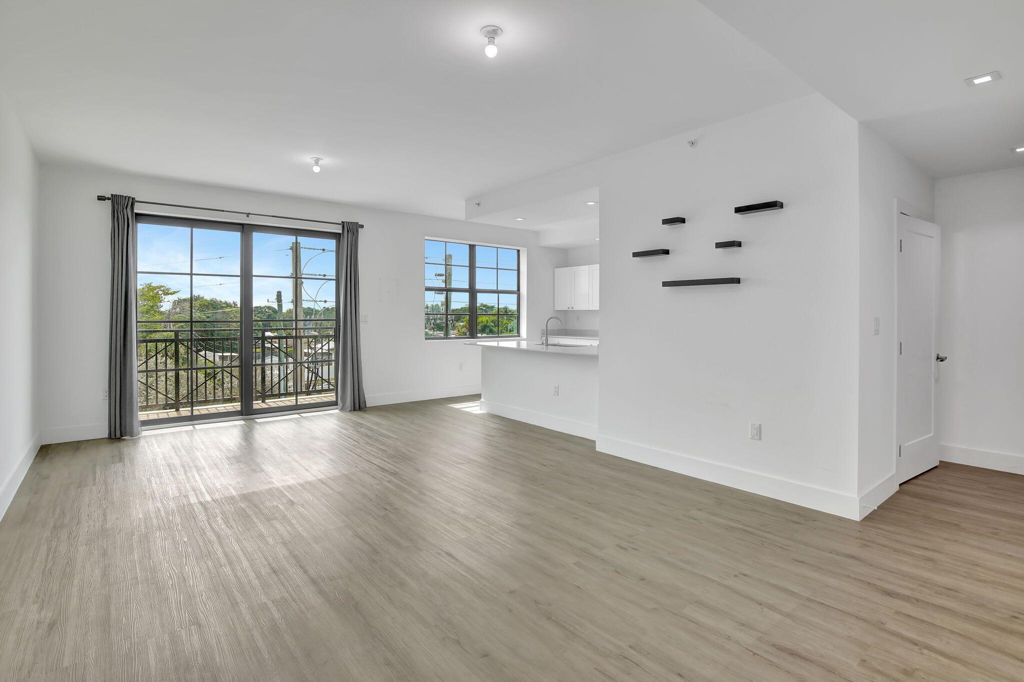 You'll love living in one of the larger 818 square foot units in Main Street Lofts. The beautiful sunsets from your 3rd story balcony are the absolute best, and coming home to nearly-new construction makes life so much better. From the gorgeous LVT flooring and quartz countertops to the impact windows and doors, this affordable condo is truly a stunner! You're located right in the heart of the city with so many things to do, and you are able to rent this property out as an investment property. Come check it out...you'll love the views!