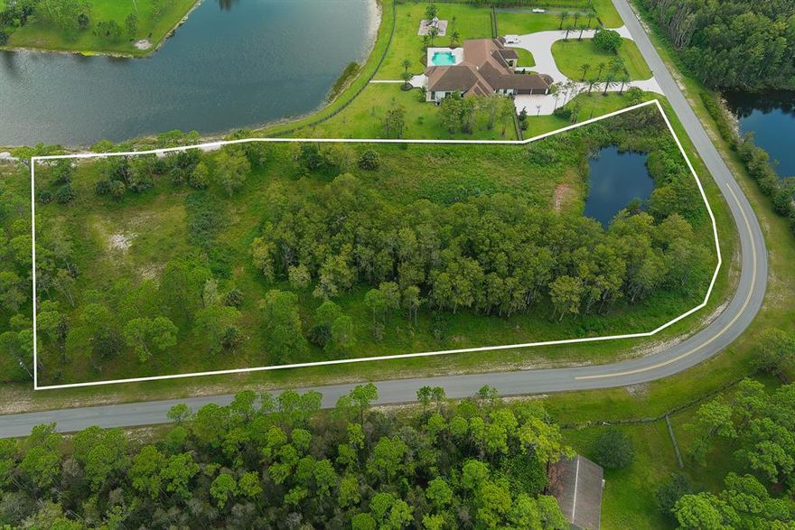 This lot is more than 5-acres with waterfrontage in the upscale community of Homeland.  Make your dream a reality by starting with this property and envisioning the luxury.   Build your equestrian estate in this established gated community with plenty of land to build horse stables, paddocks, jumping ring and more. Community has 20 miles of riding trails and is just minutes away from Wellington's equestrian venues, A- rated schools, shopping, fine dining and easy access to major highways and airports.  
This lot is also adjacent to another 5 acre lot, for sale, with water frontage.  Opportunity for vast private estate on 2 lots.  See LA for details.