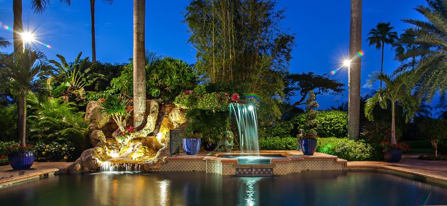 With over 65 feet of dock, situated on a wide canal just off the Intracoastal waterway, this graciously elegant estate home has been completely customized with the highest quality material in Old World Spanish Style charm. The sun-splashed brick patio is framed by the comfortable canopied lanai, summer kitchen and a graceful and private 881 square feet mahogany beamed estuary. The focal point beyond the pool & spa is the natural rock waterfall in this quiet serene setting on the water. The main house features meticulously maintained elegance and is crafted with every luxury detail. This great estate is truly a place to call home to any connoisseur of fine living.